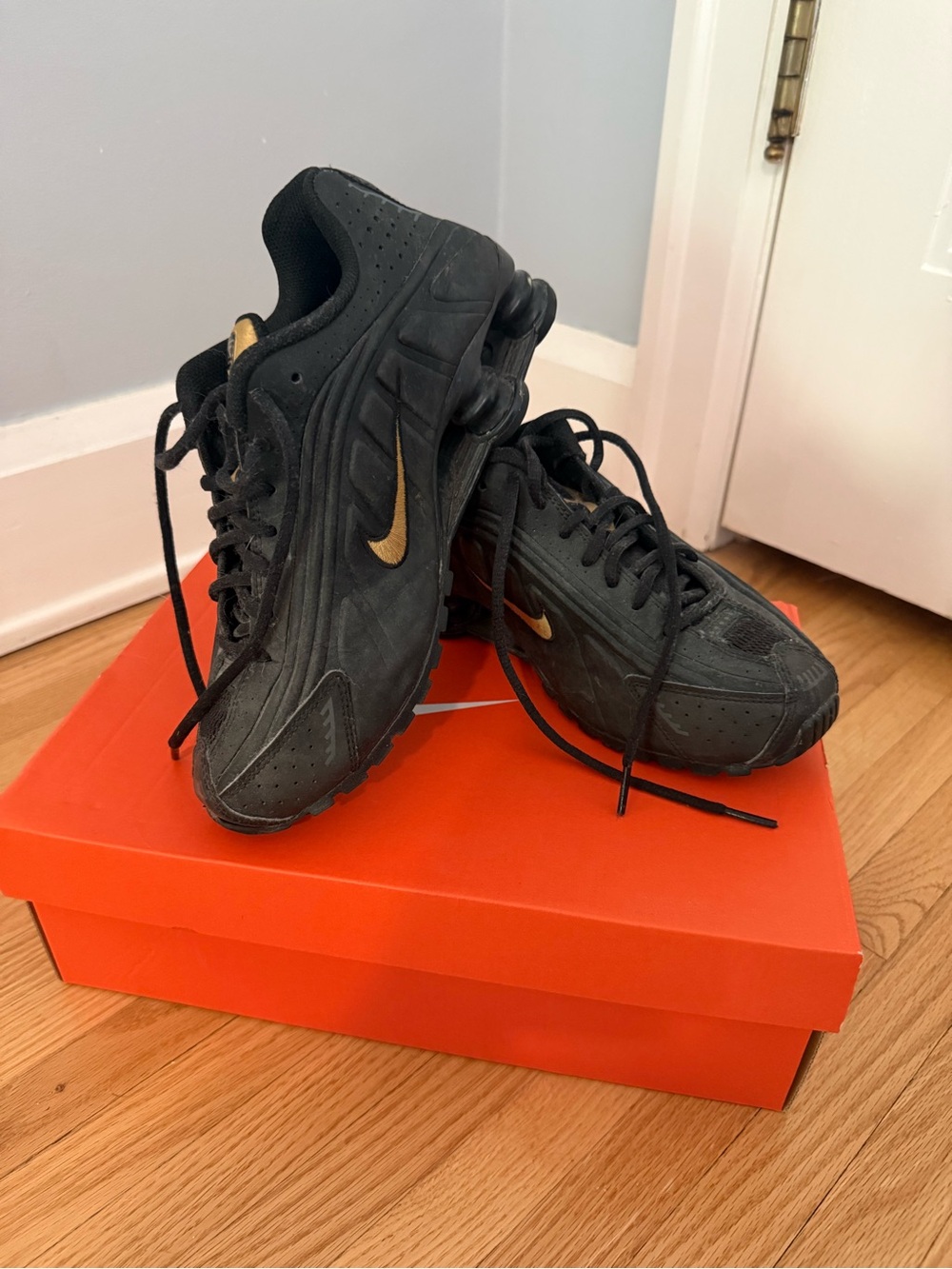Nike Black Sneakers with Gold Swoosh Accent